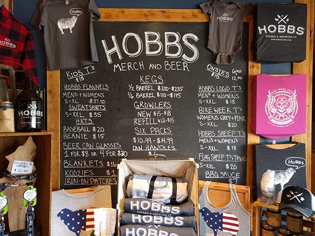 A list of to-go items from the Hobbs Tavern - including shirts, growlers, six packs, kegs, and koozies